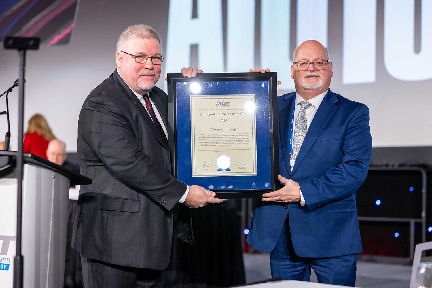 Barry Schneider (left) presented a 2024 AIST Distinguished Member and Fellow Award to Thomas L. Berringer